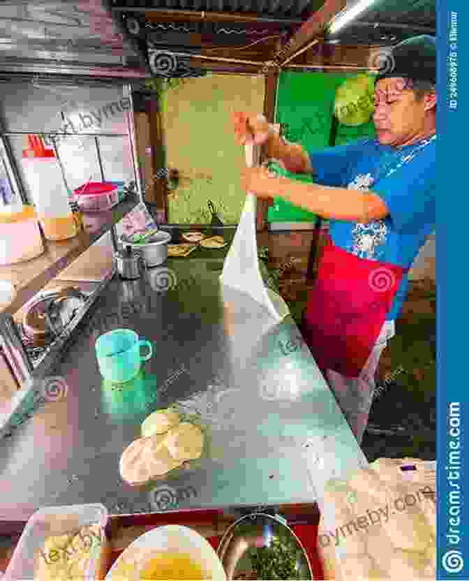 A Vendor Preparing Roti Canai, A Popular Malaysian Flatbread, On A Street Stall In Kuala Lumpur. Street Food Asia: Saigon Bangkok Kuala Lumpur Jakarta